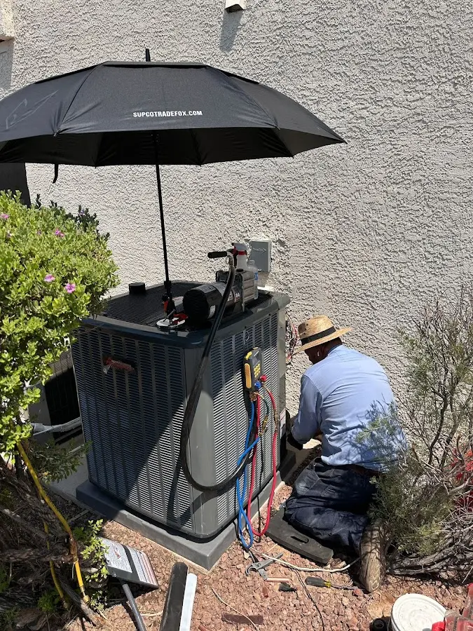 HVAC technician performing outdoor AC maintenance in Independence